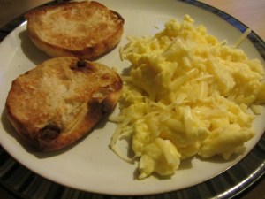 A perfect plate of scrambled eggs, topped with sharp white cheddar.