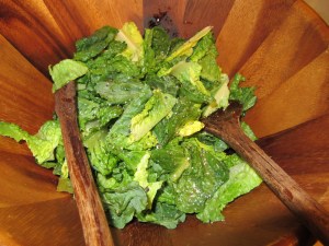 Gradually adding dressing ingredients.