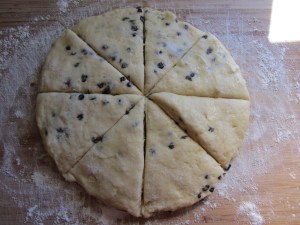 Brushed with melted butter, sprinkled with sugar, and cut into triangular scones.