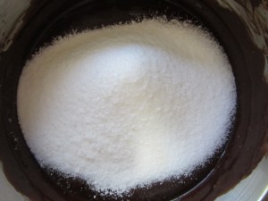 Adding the sifted dry ingredients to the chocolate.