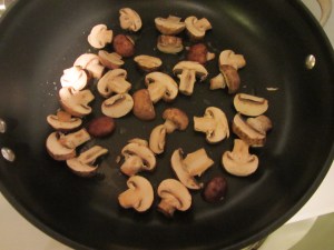 First handful of mushrooms in the hot pan.