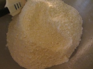 Spritzing liquid into dry mixture.