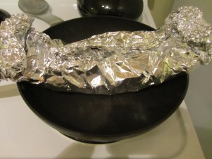 Placing ribs over pan to cut packet and get sauce.