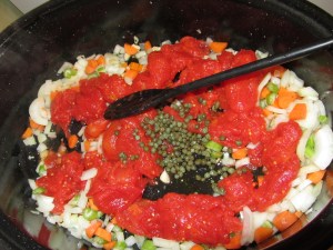 Tomatoes and capers added to vegetables.