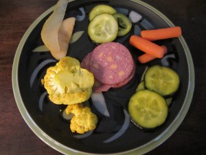 All five types of pickles on a plate, along with some summer sausage. Clockwise from the top:  Kinda Sorta Sours, Firecrackers, AB's B and Bs, Hurry Curry Cauliflower, and Summer Fruits.