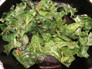 Chard added to hot duck skillet.