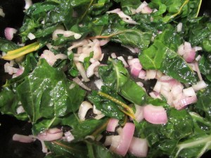 Chard and shallots in hot skillet.