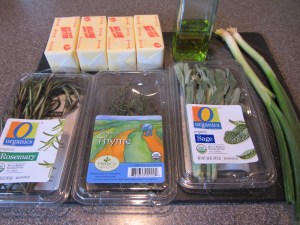 Ingredients for compound butter:  olive oil, chives, thyme, rosemary, sage, and salted butter.