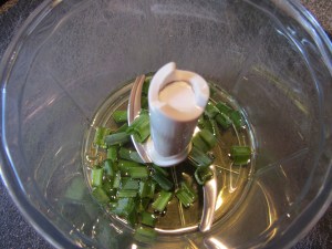Chives and olive oil in the food processor.