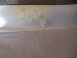 Far end of parchment pulled over butter.