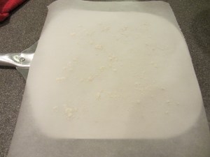 Parchment paper on metal pizza peel.