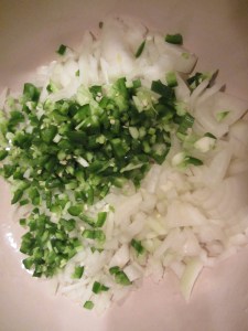 Chopped jalapenos and onion in the Dutch oven.
