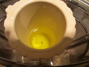 Olive oil drizzling into hummus.