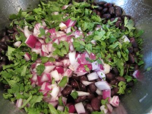 Cilantro and red onion added to beans...