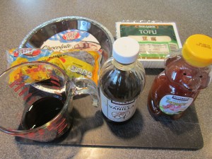 Ingredients for tofu chocolate pie:  silken tofu, semisweet chocolate chips, coffee liqueur, vanilla, honey, and a cookie crust.