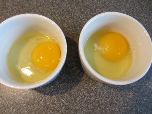 Eggs cracked into individual ramekins.