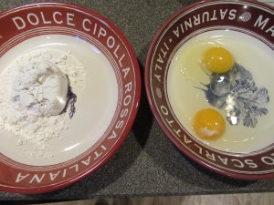 Two dredging dishes:  one with flour and one with eggs.