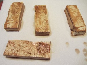 Marinated tofu on paper towels.