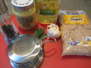 Ingredients for Alton's lamb:  Kosher salt, black pepper, Dijon mustard, mint, garlic, canola oil, and brown sugar.