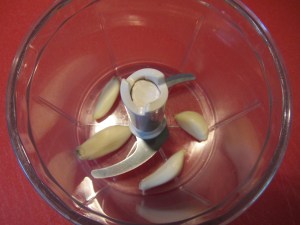 Four cloves of garlic in the chopper.