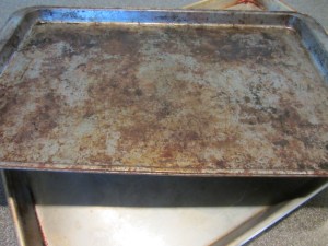 Fish sandwiched between two sheet pans. Cans were later placed on top.