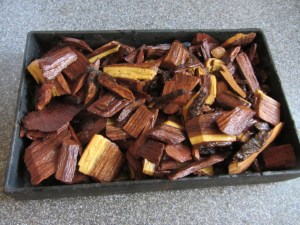 Soaked mesquite chips placed in smoking box.