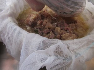 Squeezing the juice out of the meat pieces.