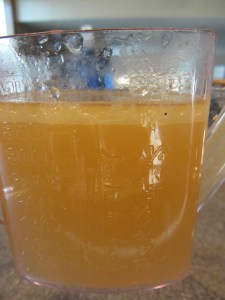 Using a gravy separator to discard the fat from the broth.