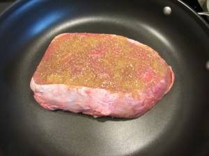 Searing the meat for 2 minutes on the first side and 3 minutes on the second.