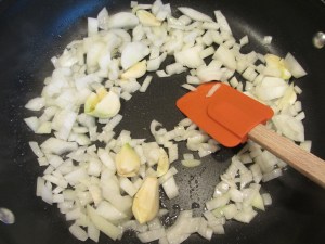 Onion and garlic added to skillet, along with oil.